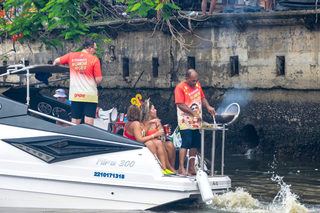 Enquanto os trios passam, os espectadores fazem sua festa nos barcos e lanchas