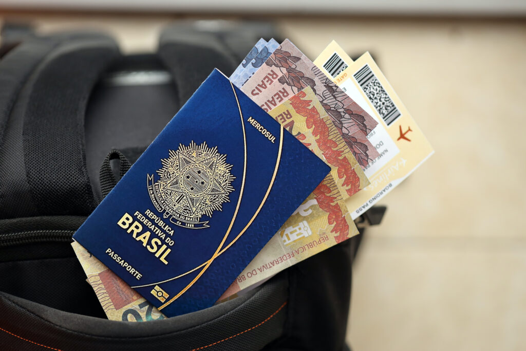 blue brazilian passport with money and airline tic 2024 11 29 18 24 48 utc BWT lança campanha com ofertas diárias para destinos nacionais e internacionais na Semana do Consumidor